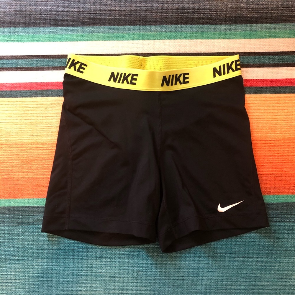 Black and neon yellow Nike compression shorts